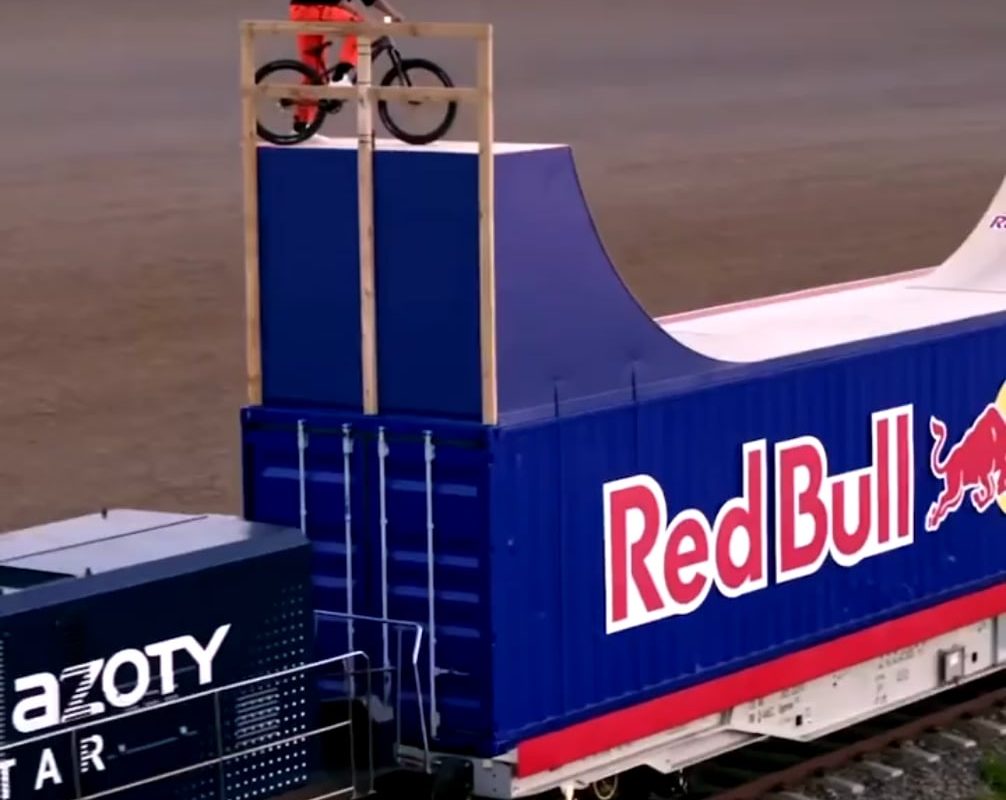 Dawid Godziek rides on top of a moving train! While doing flips…