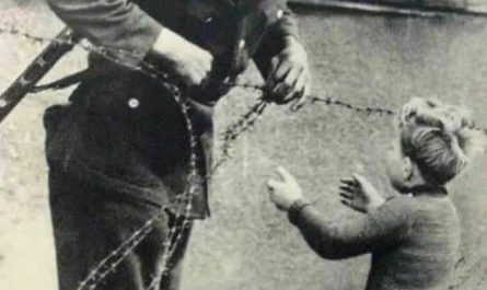 East German soldier helps a little boy sneak across the Berlin Wall the day it was erected in 1961. The boy had been left behind in the chaos of people fleeing to be with their families on either side of the wall.