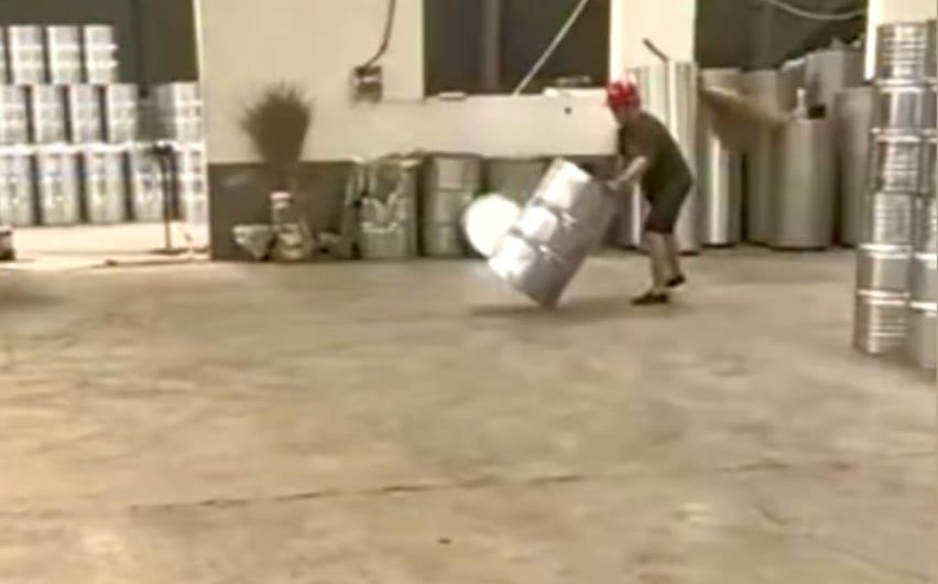 Factory worker spins barrels into place with pinpoint accuracy
