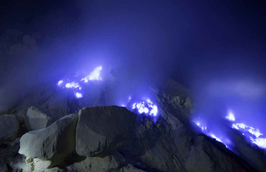 Ijen Volcano (Blue Flames) - Indonesia What's happening? It's a chemical phenomenon caused by the combustion of high-pressure sulfur gases upon contact with oxygen in the air. The distinctive color: The burning sulfur produces a bright blue flame resembling molten lava.