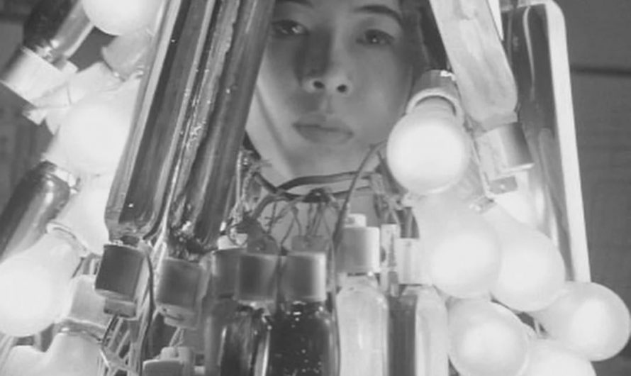 Japanese artist Atsuko Tanaka (1932-2005) wearing her Electric Dress a garment made out of 200 working lightbulbs, 1956.