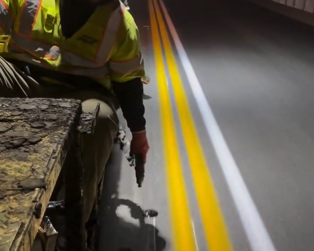 Laying reflective road markers