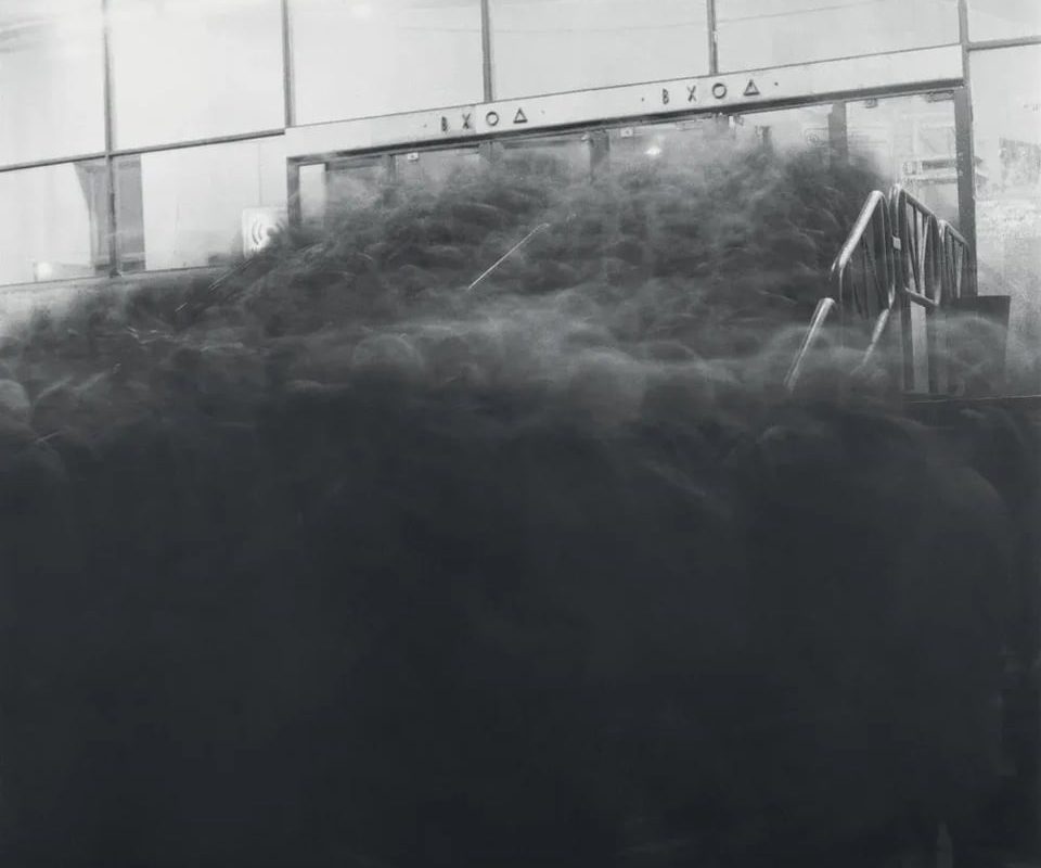 Long exposure photograph of a crowd near the entrance to the Vasileostrovskaya subway station in Saint Petersburg (1991) by Russian photographer Alexey Titarenko from the book "City of shadows"