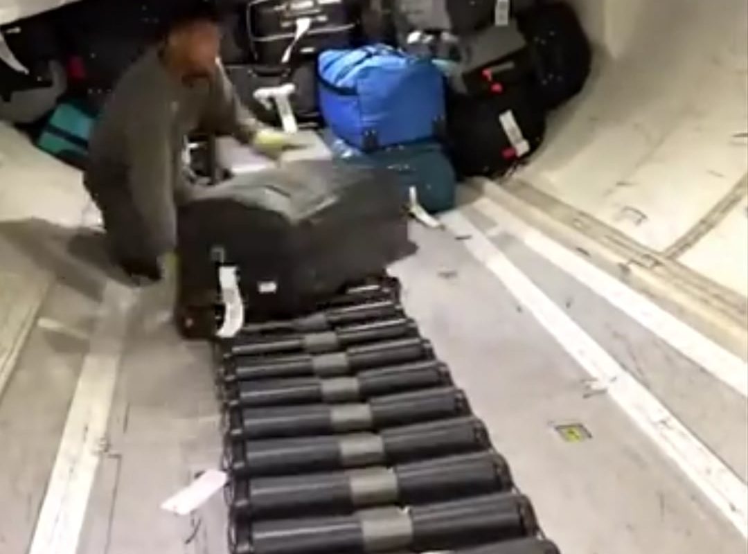 Luggages being neatly stacked to a plane compartment