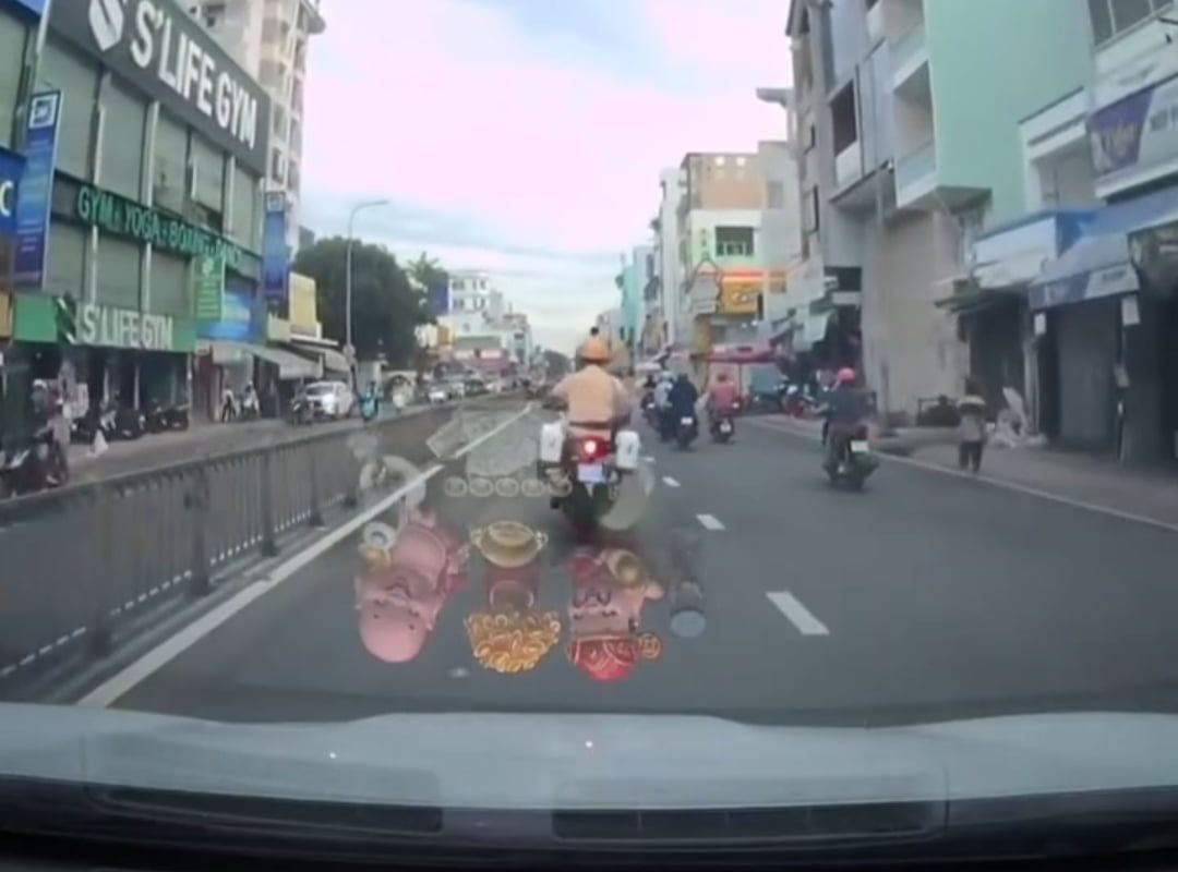 Motorbike cop maneuvering through heavy traffic in Vietnam to escort a woman in labor to the hospital