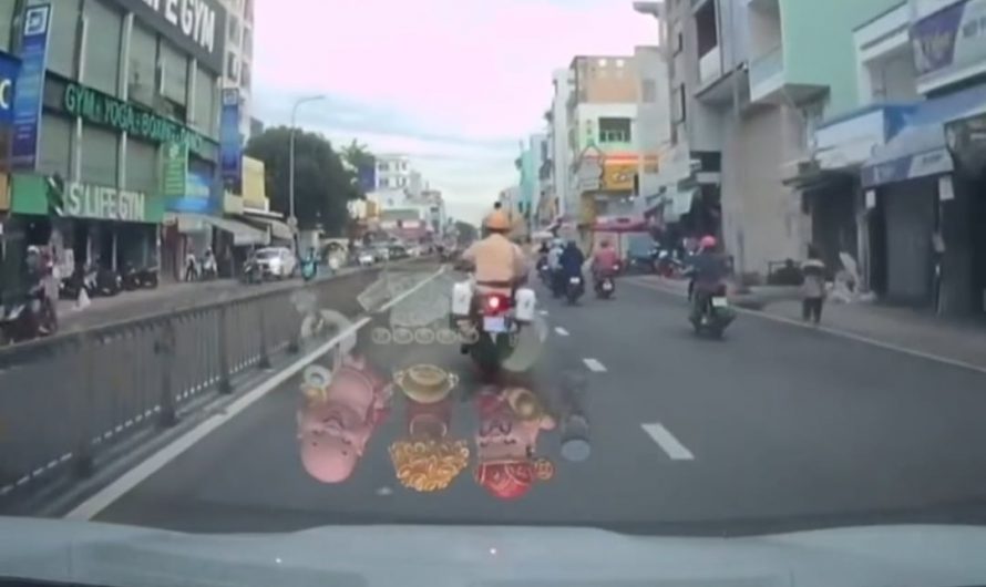 Motorbike cop maneuvering through heavy traffic in Vietnam to escort a woman in labor to the hospital