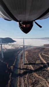 POV from a wingsuit of going in between an arch of a bridge