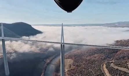 POV from a wingsuit of going in between an arch of a bridge