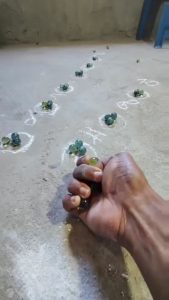 Perfectly aiming marbles with thumb (marbles game)