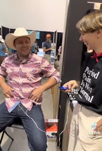 Placing a period pain simulator on a cowboy