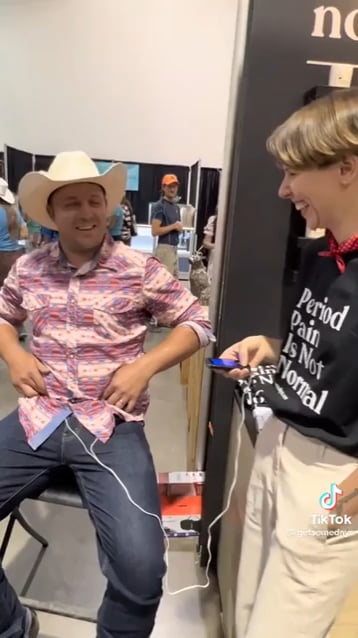 Placing a period pain simulator on a cowboy