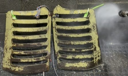 Pressure washing the paint and rust off this tractor grill after a chemical alkaline bath then an acid bath.