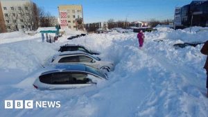 Record snowfall leaves cars stuck and people stranded in Russia's Far East