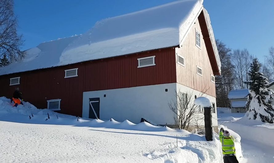 Removing snow from roof with a rope in Norway