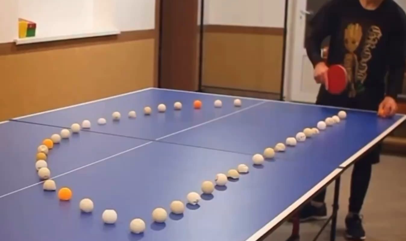 Rolling ping pong ball hit by bouncing ping pong ball