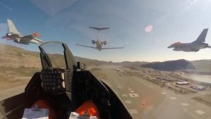 Royal Danish Air Force F-16s on low-level flight over Greenland, overflying a Danish Navy vessel and radar station