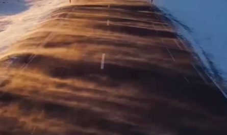 Snow blowing across a road in Iceland