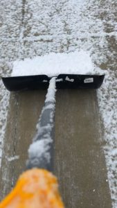 Snow piling up on the shovel