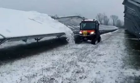 Snow tractor removes snow off of the solar panel
