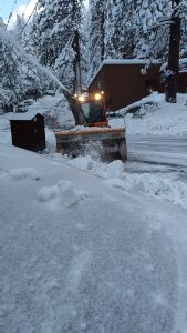 Snowplow clearing driveway