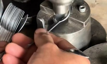 Spoons being pressed into shape