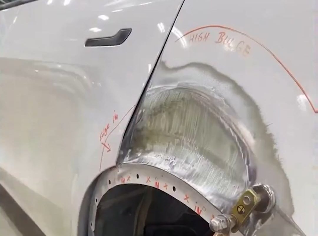 Stud welding and pulling technique used to straighten and restore damaged car panels without replacing them.