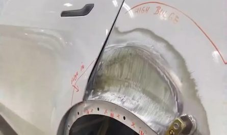 Stud welding and pulling technique used to straighten and restore damaged car panels without replacing them.