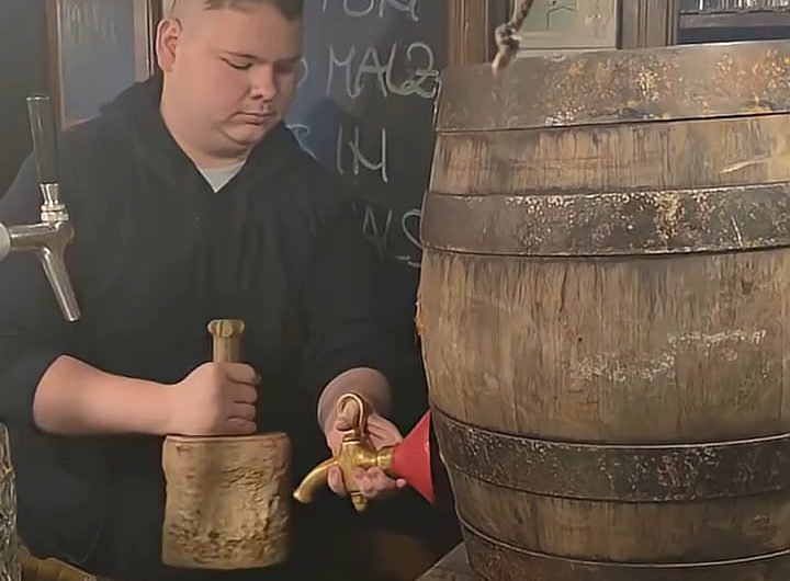 Tapping a traditional wooden keg in Munich