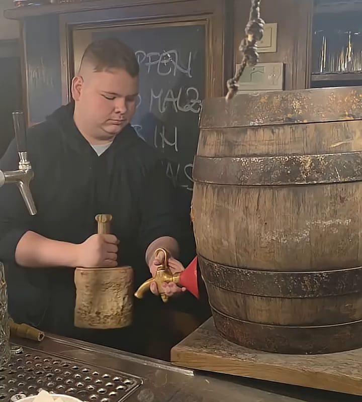 Tapping a traditional wooden keg in Munich