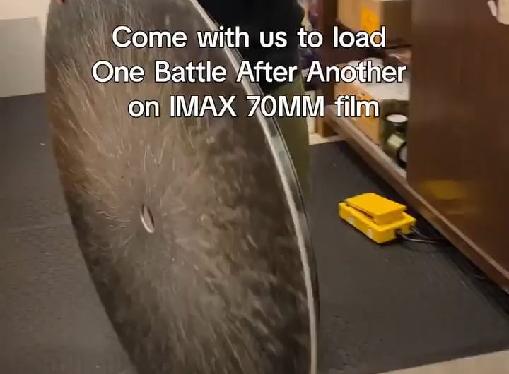 The loading of an IMAX film into the projector