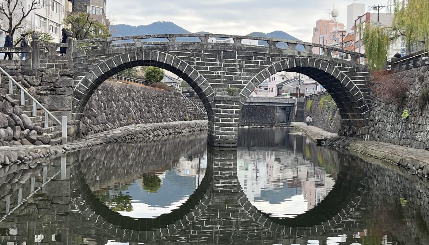 The reflection of this bridge’s arcs make two ovals.