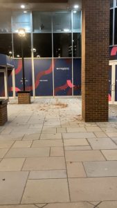 The wind helping leaves & downtown detritus do a short, spinning dance