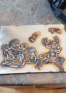 This Santa is drawn completely on metal with a welder