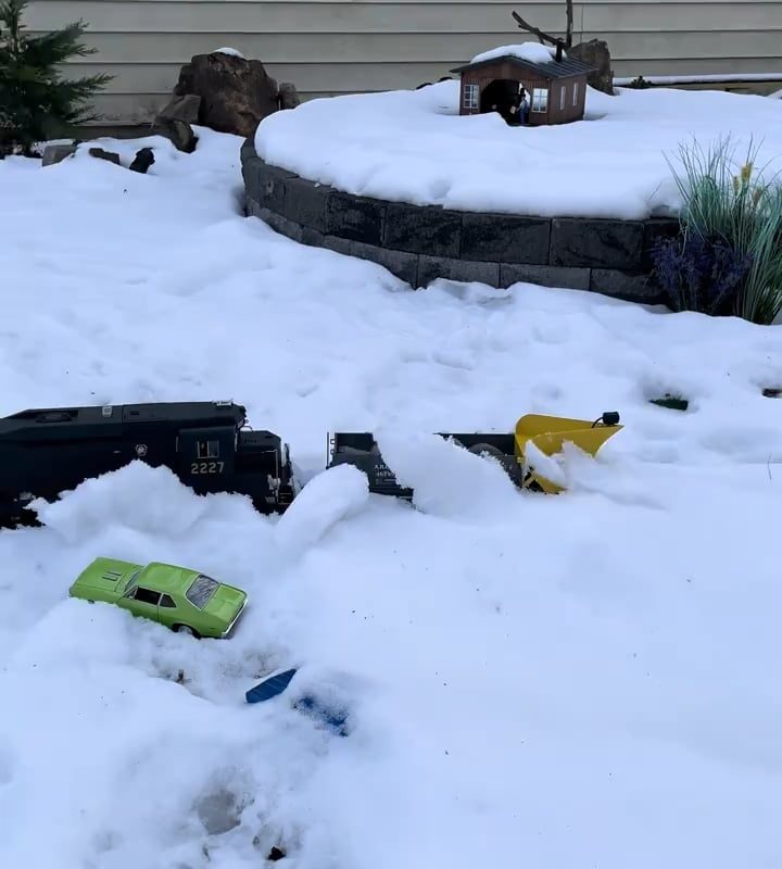 Toy train plowing the snow from its tracks