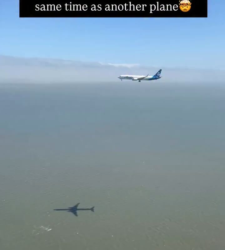 Two planes landing simultaneously on parallel runways at the same airport — perfectly timed.