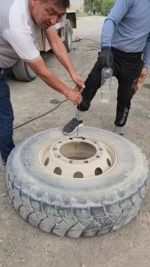 Water bottle balancing in a jet of air releasing from a tyre