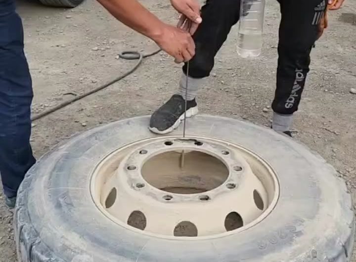 Water bottle balancing in a jet of air releasing from a tyre