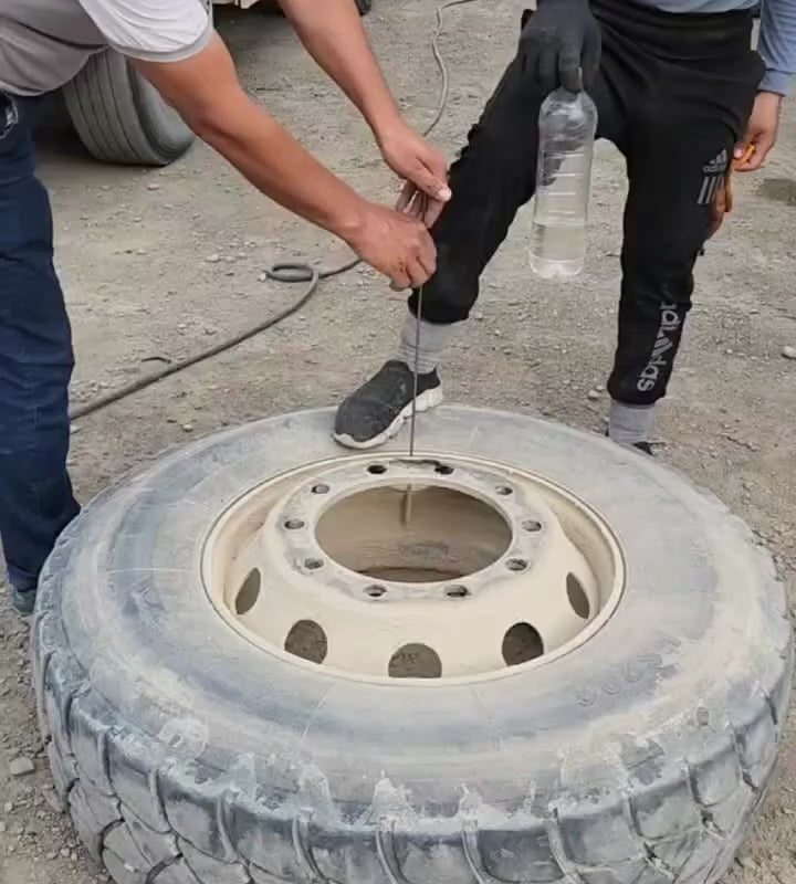 Water bottle balancing in a jet of air releasing from a tyre