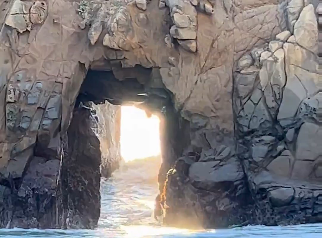 Waves crashing through Keyhole Arch, California