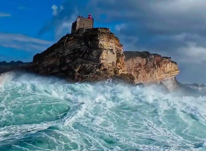 Waves hides a cliff in Nazaré – Portugal