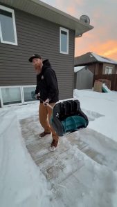 clearing a thick layer of snow on the ground
