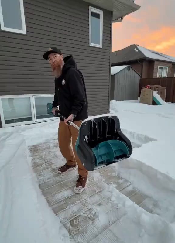 clearing a thick layer of snow on the ground