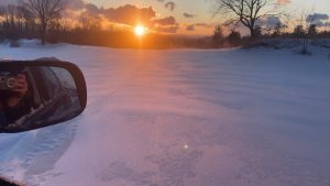 snow wisps at sunset