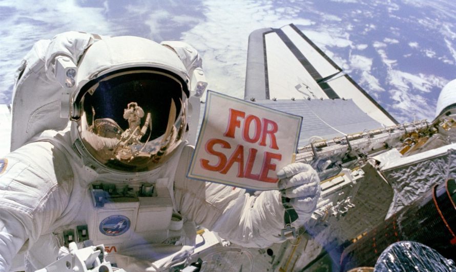 Astronaut Dale A. Gardner holds up a “For Sale” sign as a joke, pretending to offer up two failed satellites, Palapa B-2 and Westar 6, which were retrieved in space during the shuttle Discovery’s STS-51A mission in 1984. Astronaut Joseph P. Allen IV can be seen reflected in Gardner’s helmet visor.