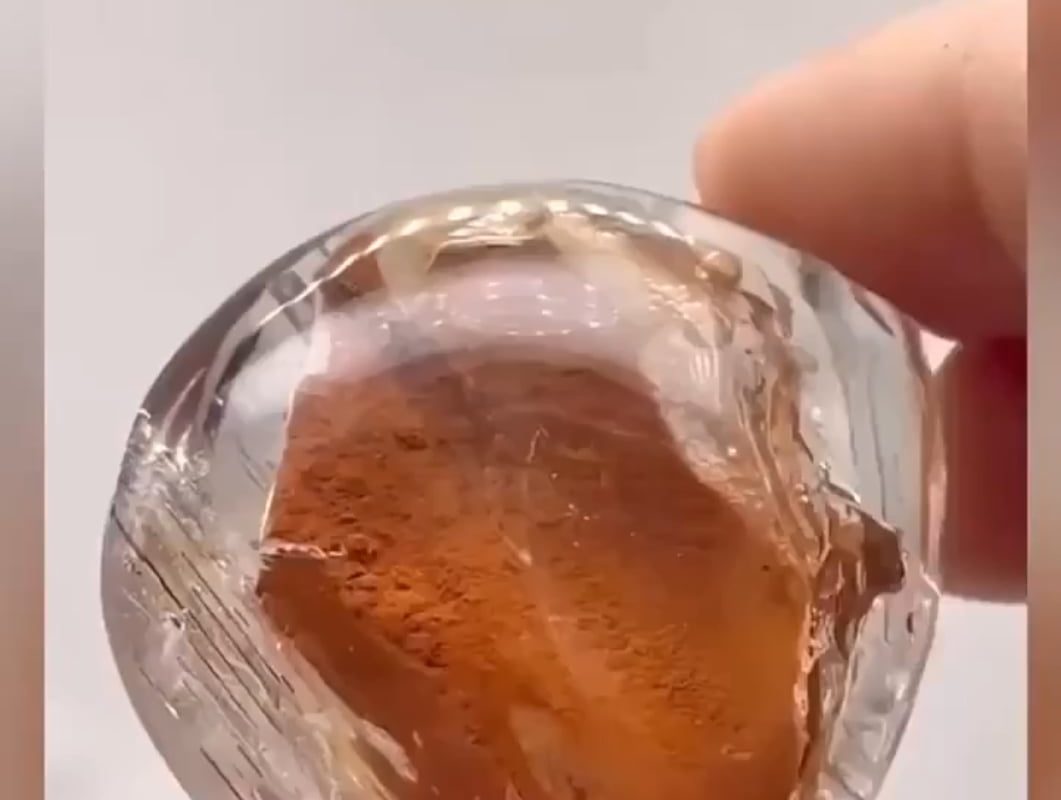Fine sand and water trapped inside an enhydro quartz crystal for hundreds of millions of years