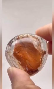 Fine sand and water trapped inside an enhydro quartz crystal for hundreds of millions of years