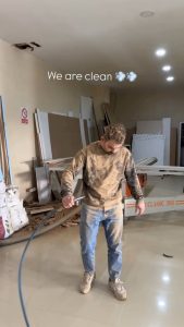 Guy uses air pressure to clean dust off