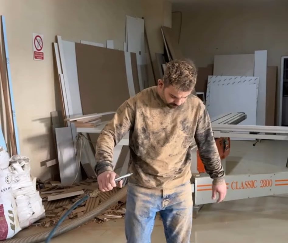 Guy uses air pressure to clean dust off