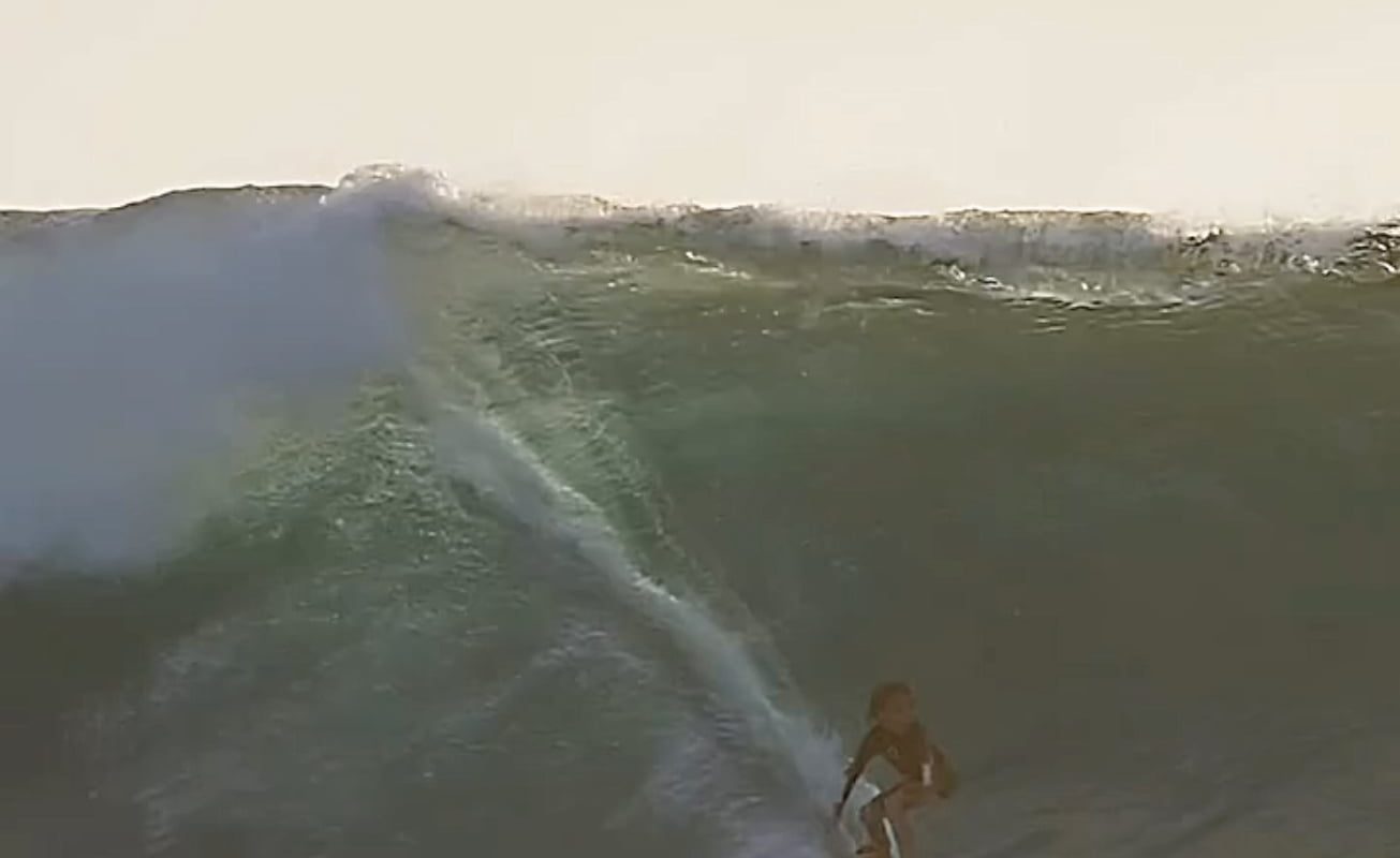 He was surfing and a flying fish decided to join him through waves