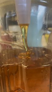 Honey flowing out of funnel